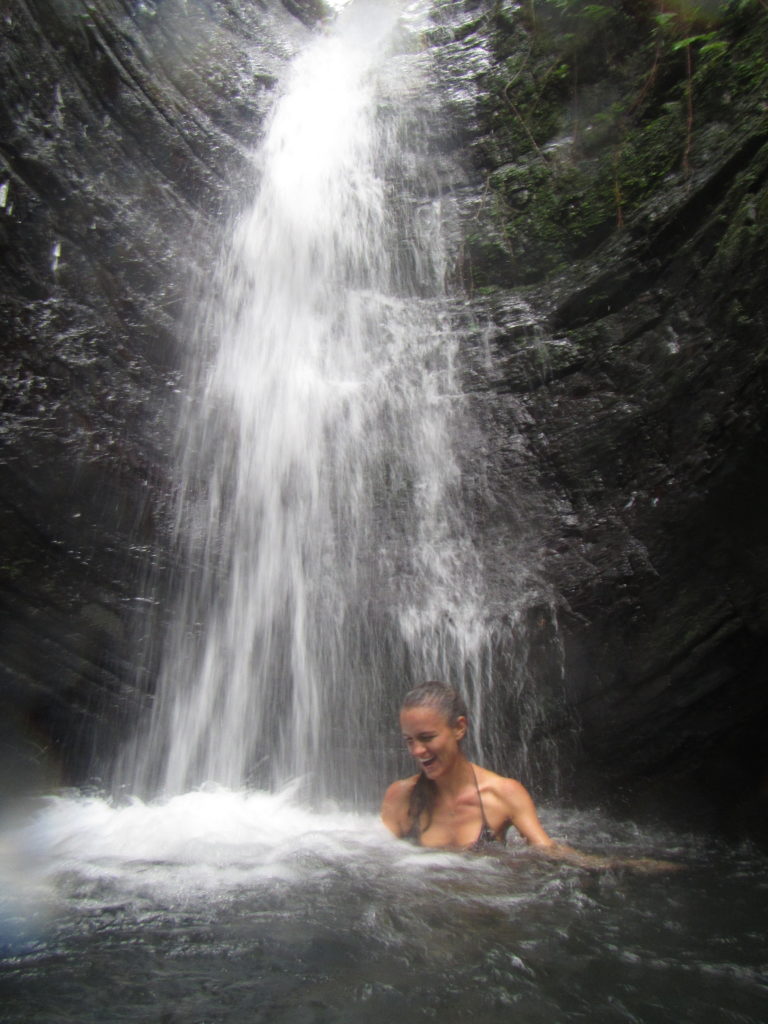happy under a waterfall in puerto rico